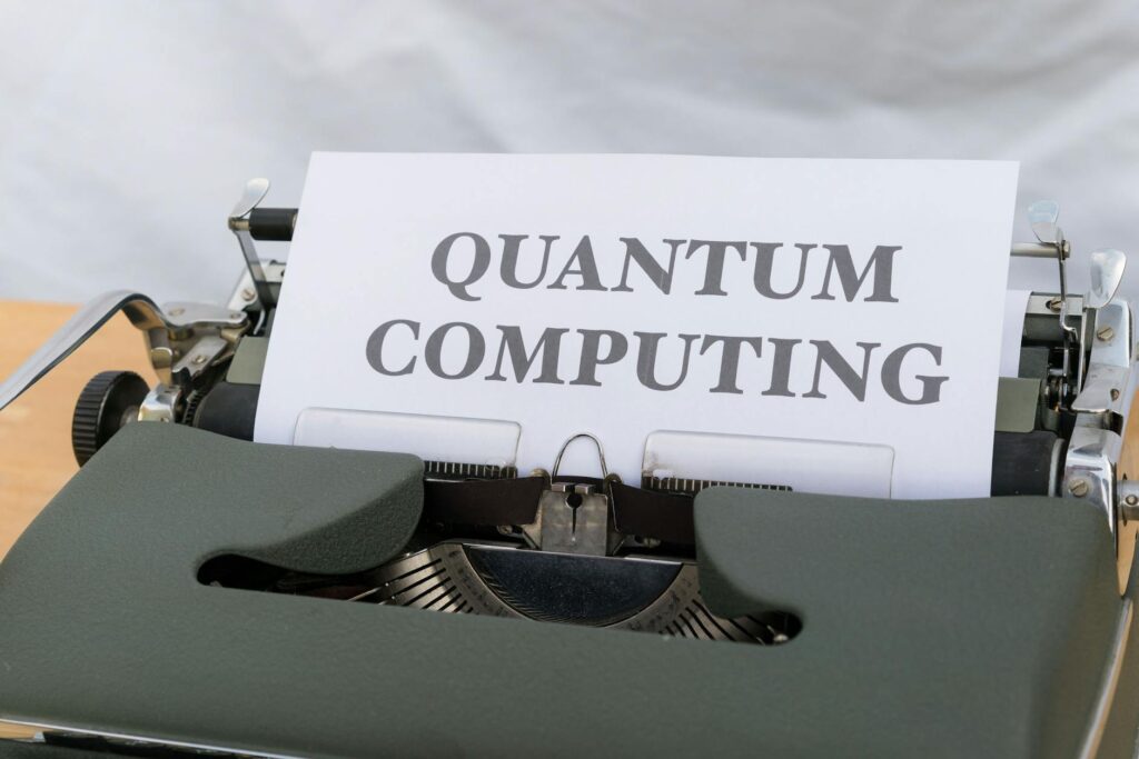 A vintage typewriter with a paper displaying the term Quantum Computing.