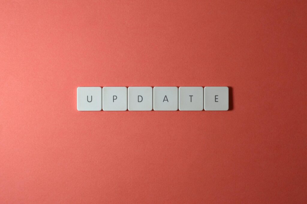 Keyboard keys arranged to spell 'update' on a vibrant red background, ideal for conveying tech concepts.