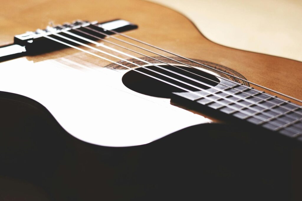 Detailed image of an acoustic nylon-string guitar showcasing its craftsmanship and elegance.